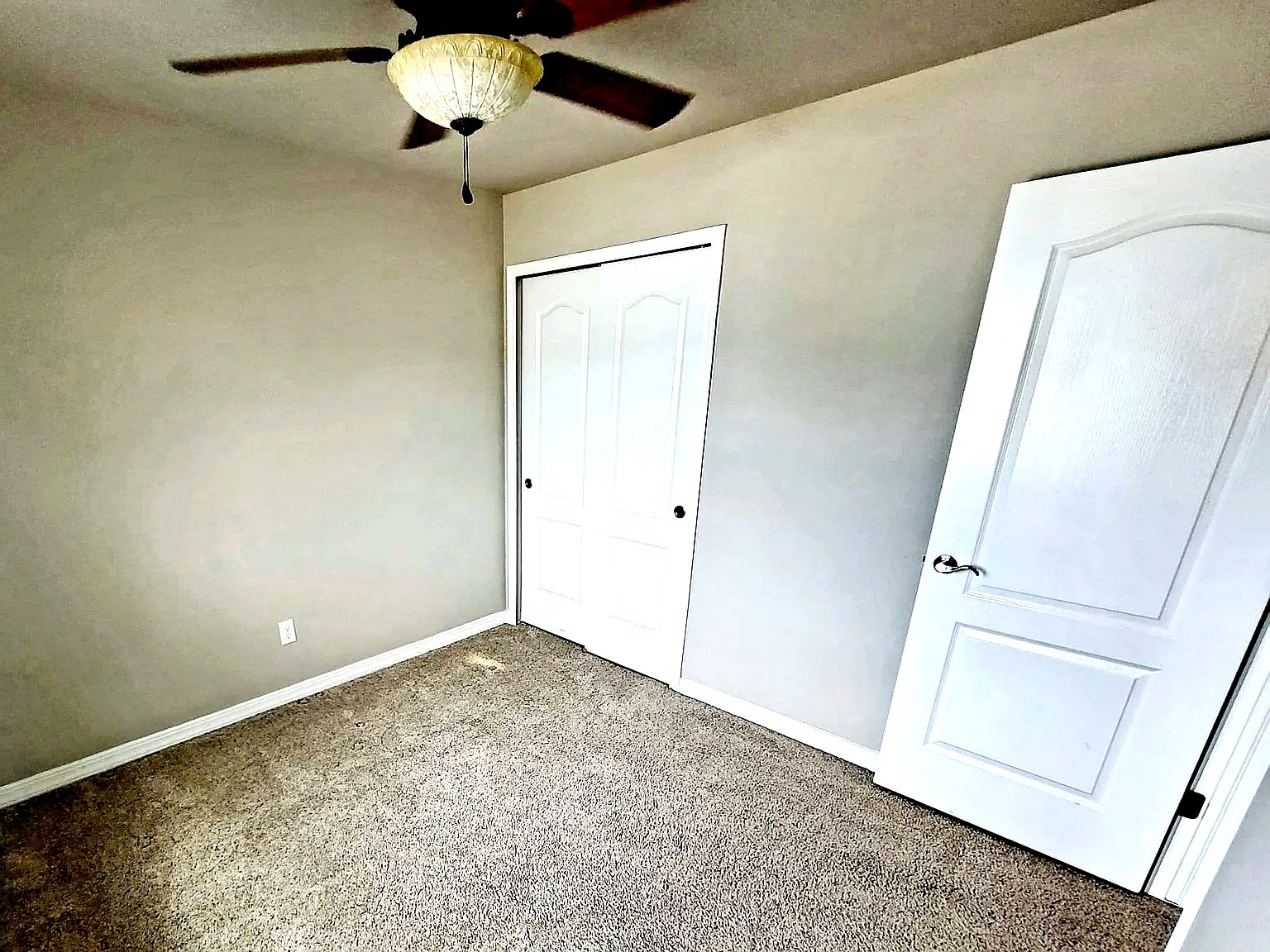 Third bedroom with ceiling fan and double closets
