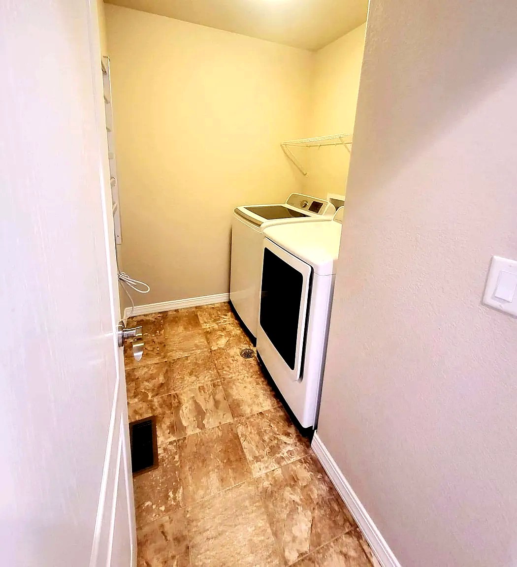 In-unit laundry room with full-size washer and dryer