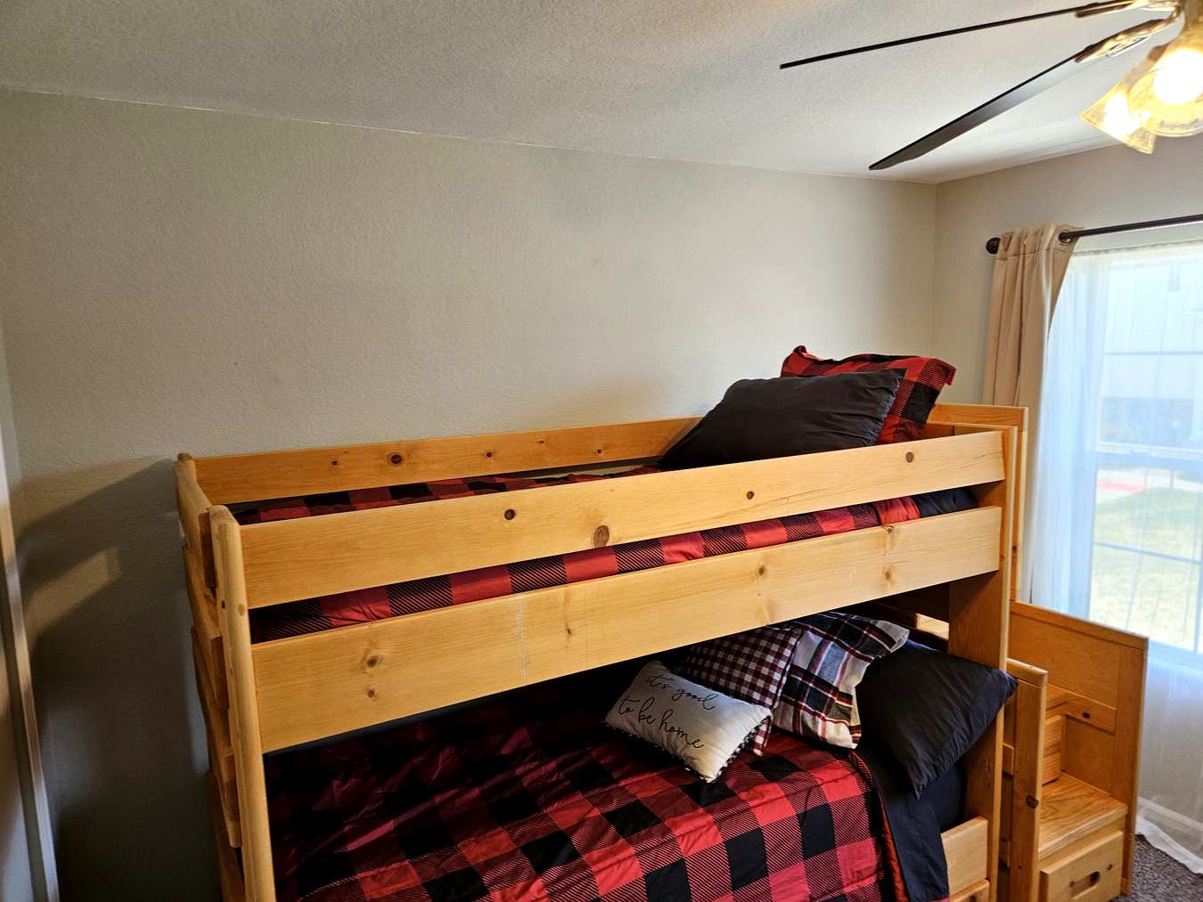 Bunk bed room with pine beds and buffalo plaid bedding