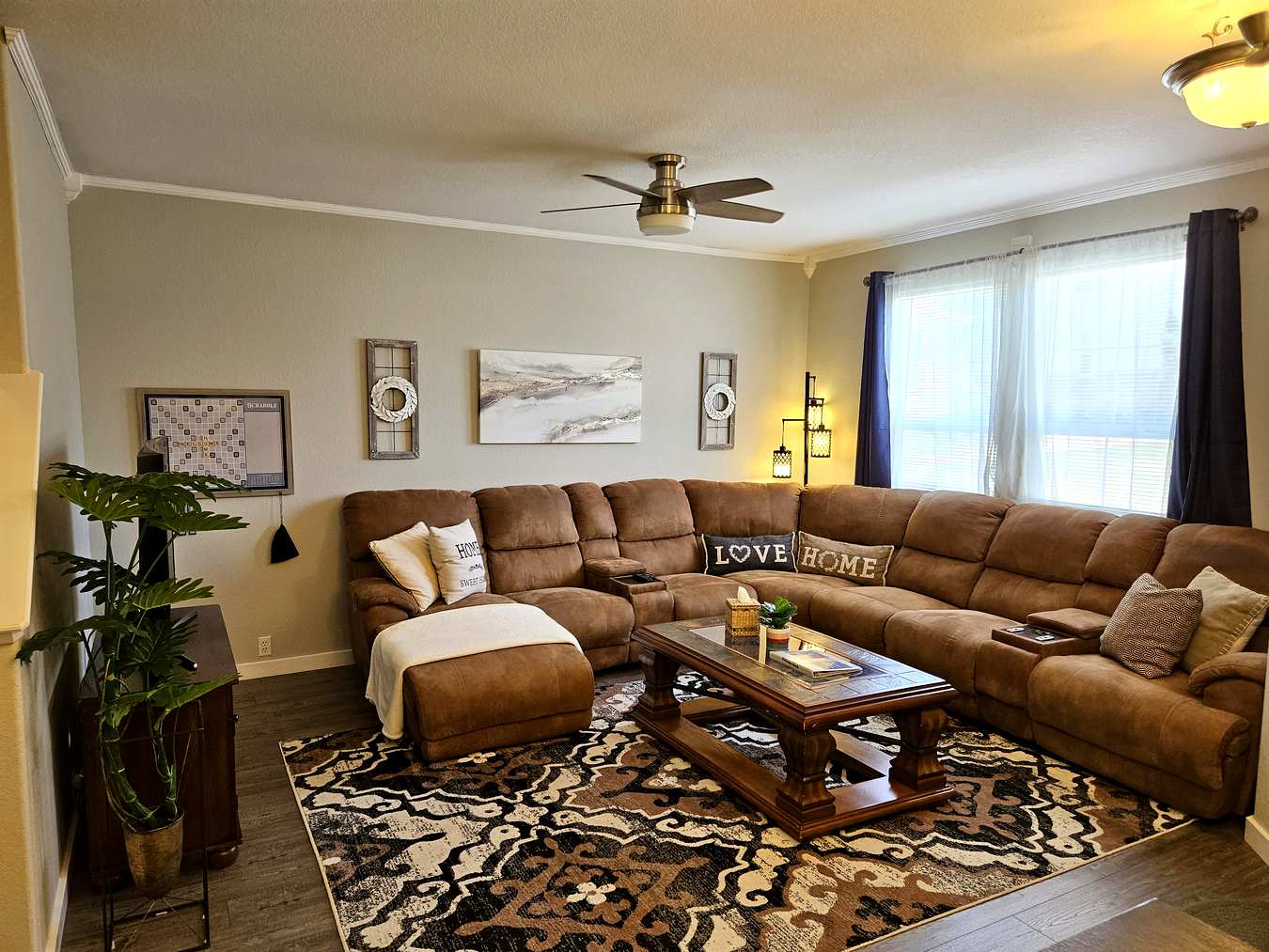 Spacious living room with large sectional sofa and hardwood floors