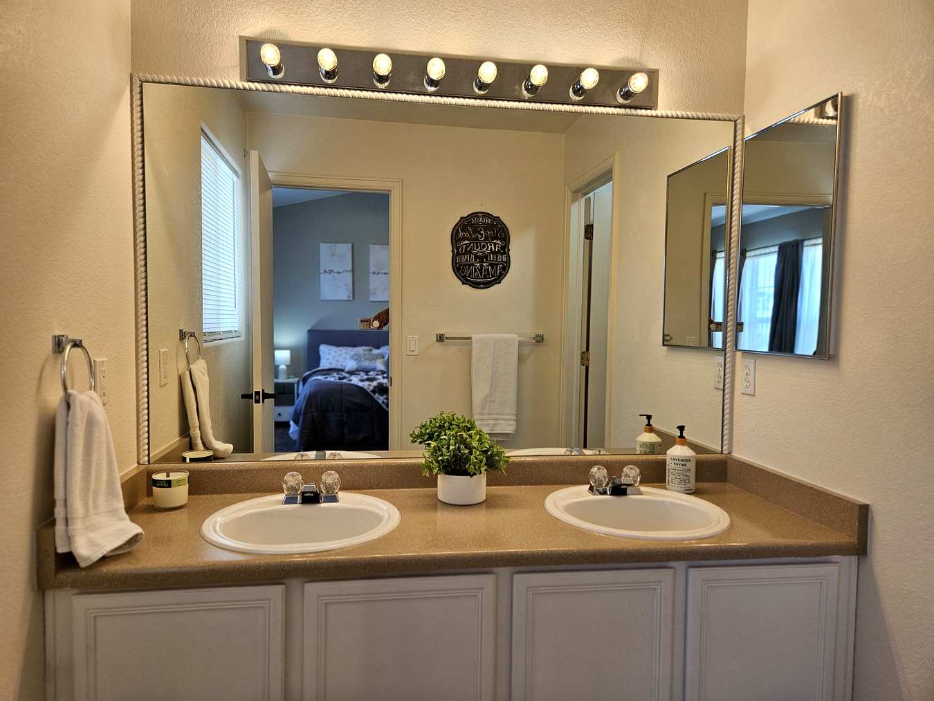 Master bathroom with double vanity and Hollywood mirror lights