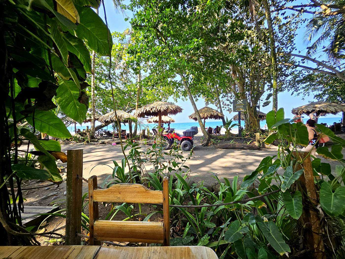 Beachside cafe through tropical foliage near Playa Negra