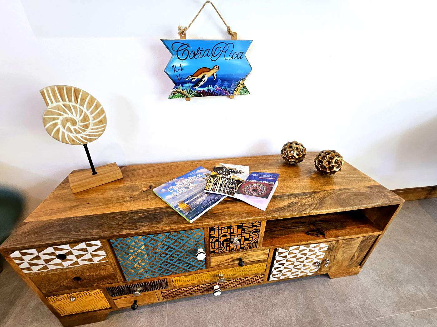 Living room console with colorful drawers and Costa Rica travel books