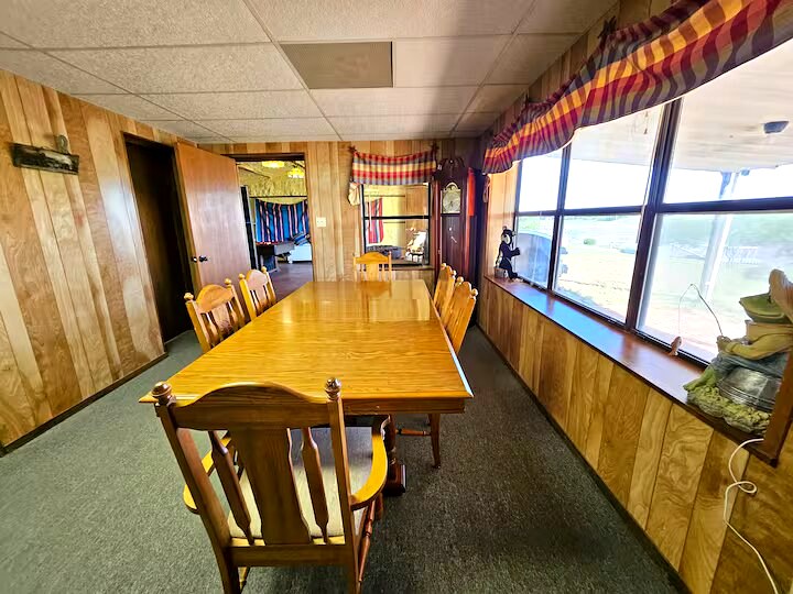 Dining room with long table seating 8 guests