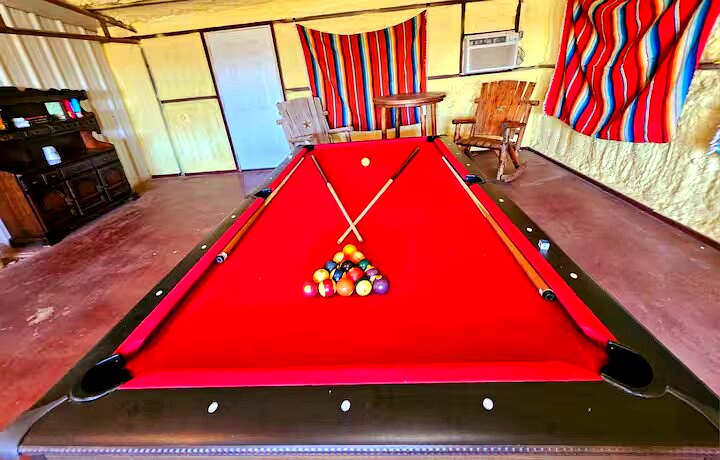 Game room with pool table and string lights