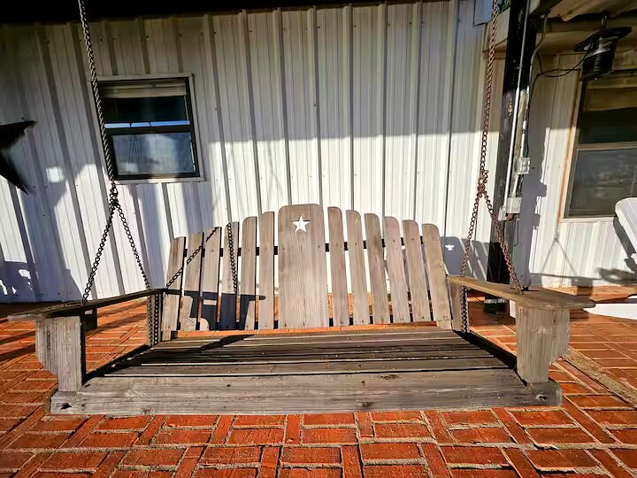 Porch swing with lake view at Papi's Lake House